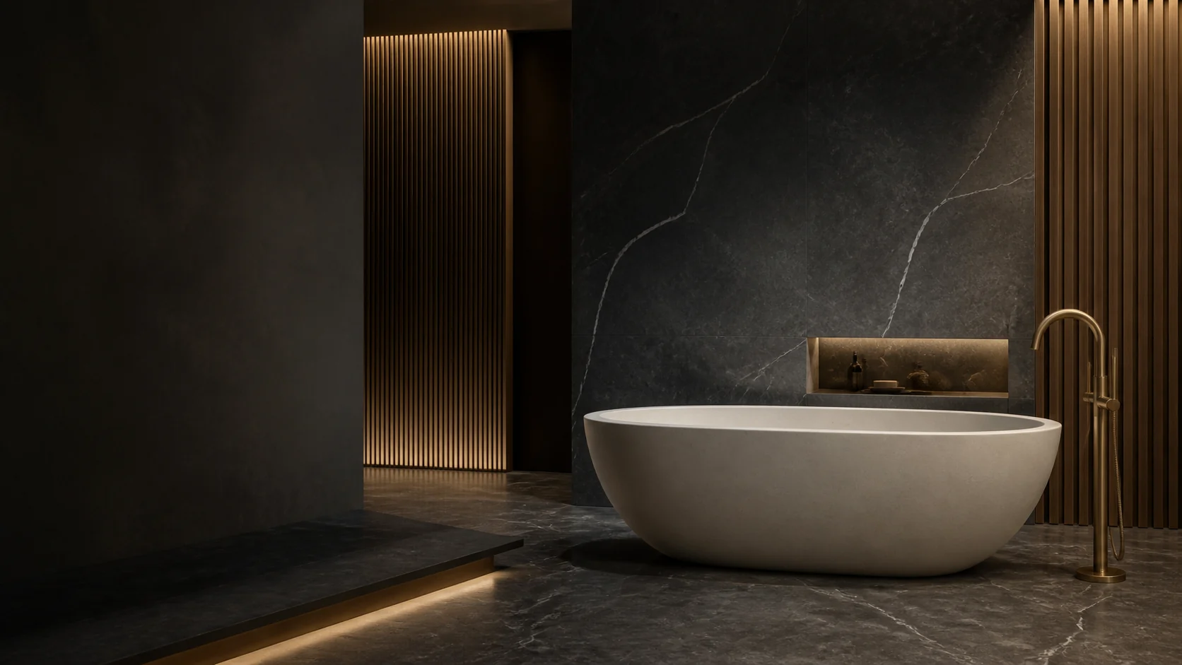 Oval stone bathtub in a charcoal and brass spa interior